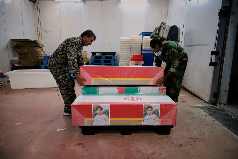 Coffins holding the bodies of mostly children are prepared for the funeral of those killed in what Iranian officials said was an Israeli-U.S. strike Feb. 28 at a girls' elementary school in Minab, Iran, Tuesday, March 3, 2026. (Amirhossein Khorgooei/ISNA via AP)